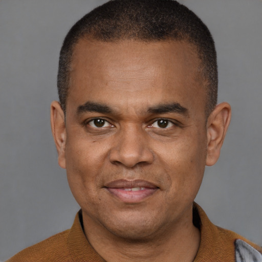 Joyful latino adult male with short  brown hair and brown eyes