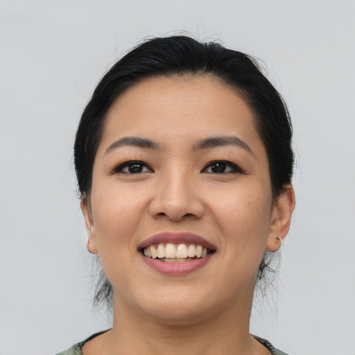 Joyful asian young-adult female with medium  black hair and brown eyes