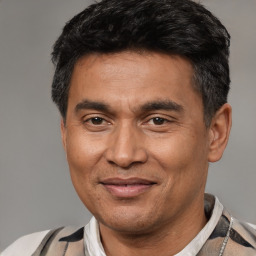 Joyful white adult male with short  black hair and brown eyes