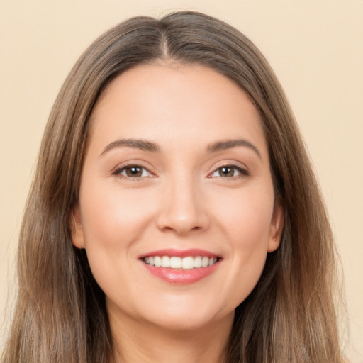 Joyful white young-adult female with long  brown hair and brown eyes