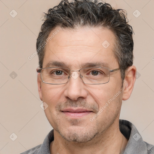 Joyful white adult male with short  black hair and brown eyes