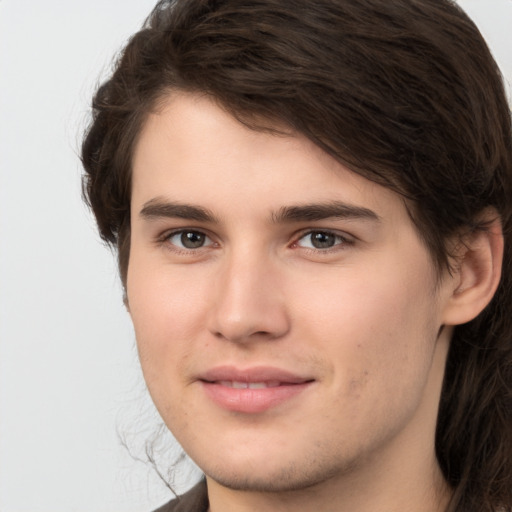 Joyful white young-adult male with medium  brown hair and brown eyes