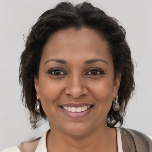 Joyful black young-adult female with medium  brown hair and brown eyes