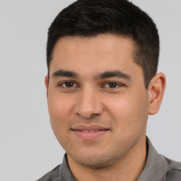 Joyful white young-adult male with short  black hair and brown eyes