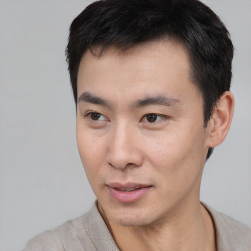 Neutral asian young-adult male with short  brown hair and brown eyes