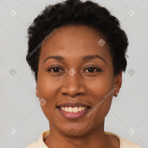 Joyful black young-adult female with short  brown hair and brown eyes