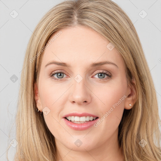 Joyful white young-adult female with long  brown hair and blue eyes