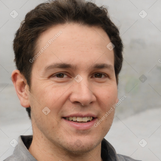 Joyful white adult male with short  brown hair and grey eyes