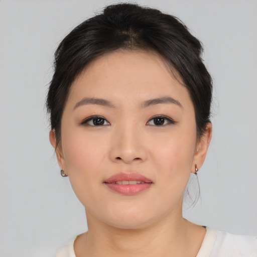 Joyful asian young-adult female with medium  brown hair and brown eyes