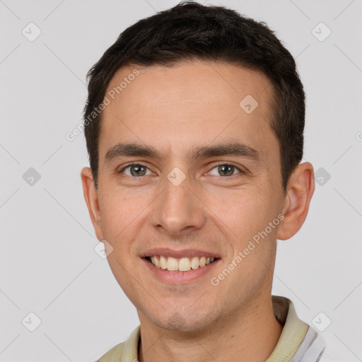 Joyful white young-adult male with short  brown hair and brown eyes