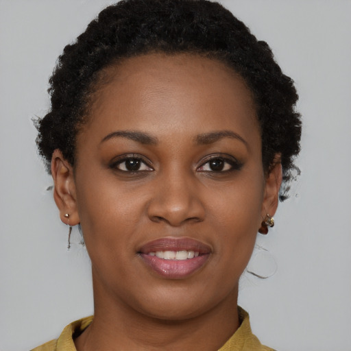 Joyful black young-adult female with short  brown hair and brown eyes
