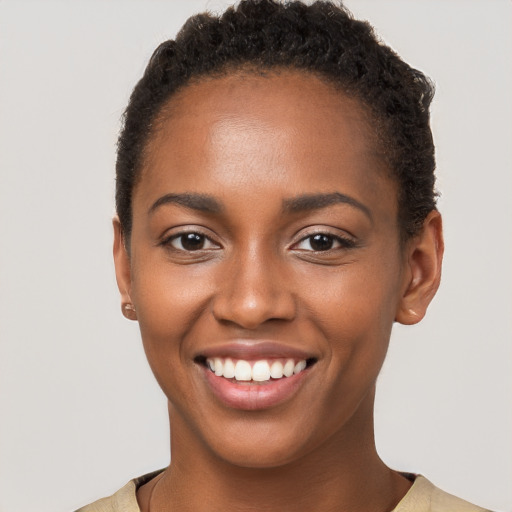 Joyful black young-adult female with short  brown hair and brown eyes