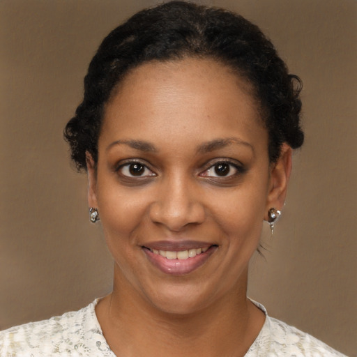 Joyful black young-adult female with short  brown hair and brown eyes