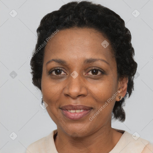 Joyful black adult female with short  brown hair and brown eyes