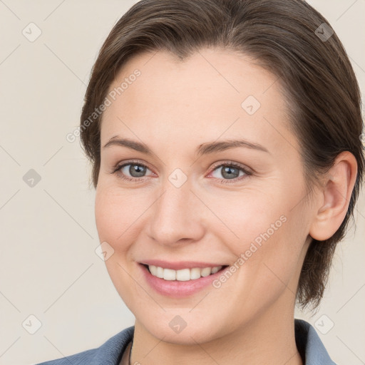 Joyful white young-adult female with medium  brown hair and grey eyes