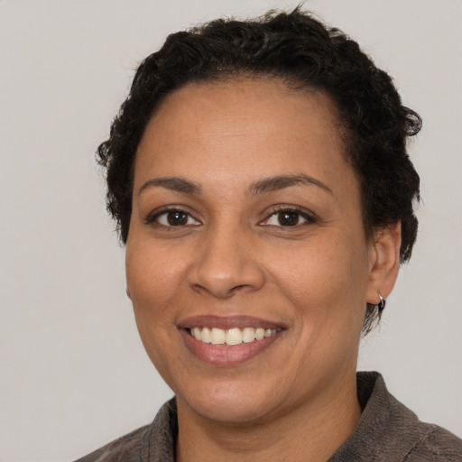 Joyful white adult female with short  brown hair and brown eyes