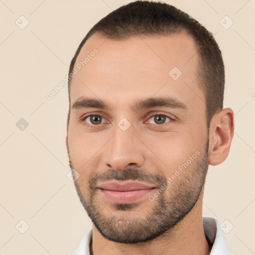 Joyful white young-adult male with short  brown hair and brown eyes