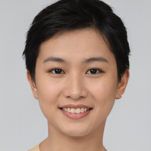 Joyful asian young-adult female with short  brown hair and brown eyes