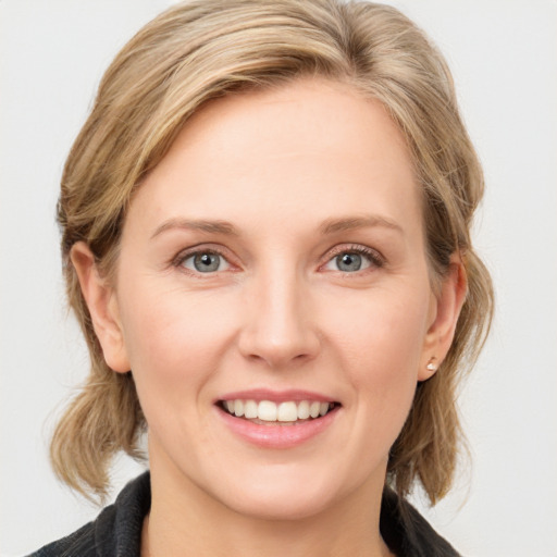 Joyful white young-adult female with medium  brown hair and blue eyes