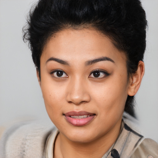 Joyful asian young-adult female with short  brown hair and brown eyes