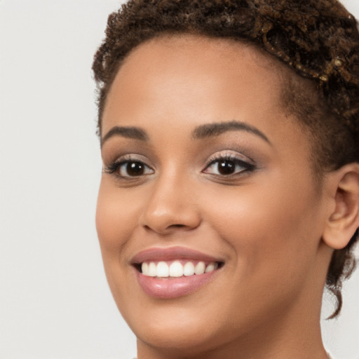 Joyful latino young-adult female with short  brown hair and brown eyes