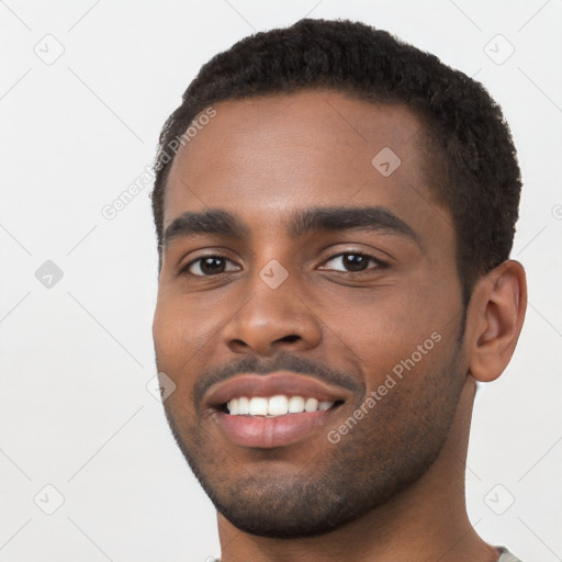 Joyful black young-adult male with short  black hair and brown eyes