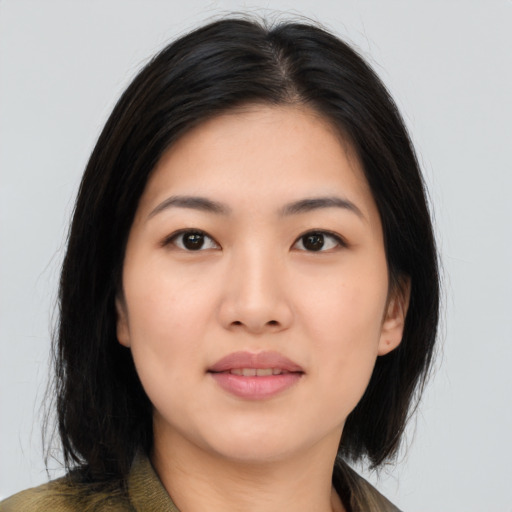 Joyful asian young-adult female with long  black hair and brown eyes