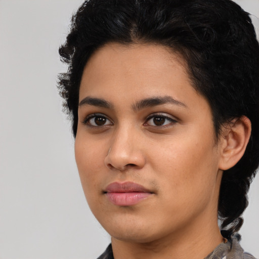 Joyful latino young-adult female with short  black hair and brown eyes
