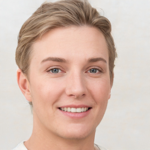 Joyful white young-adult female with short  brown hair and grey eyes