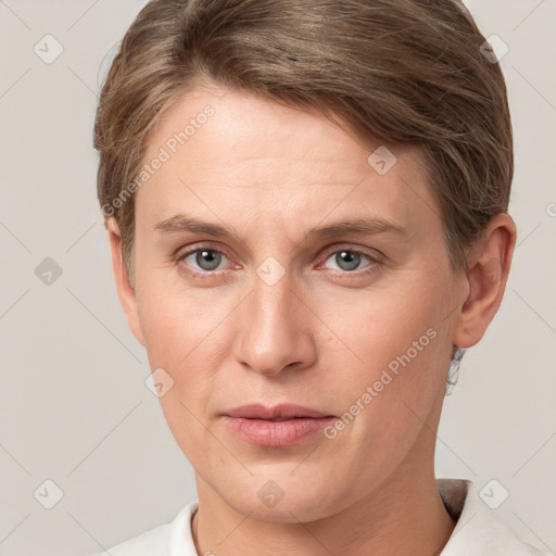 Joyful white young-adult female with short  brown hair and grey eyes