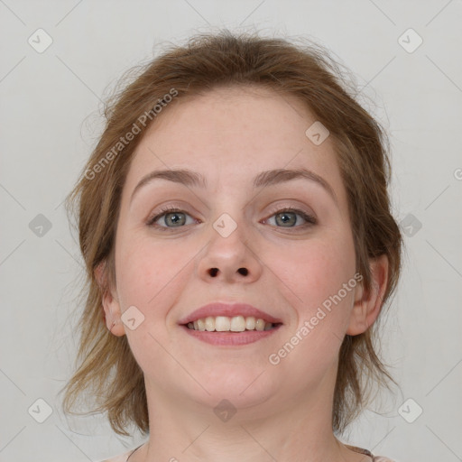 Joyful white young-adult female with medium  brown hair and grey eyes