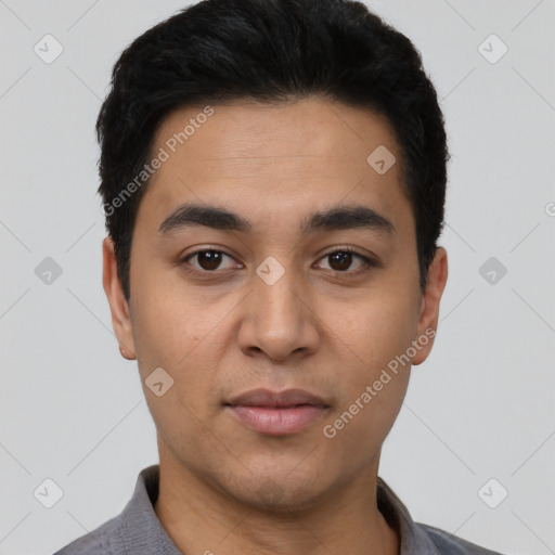 Joyful latino young-adult male with short  black hair and brown eyes