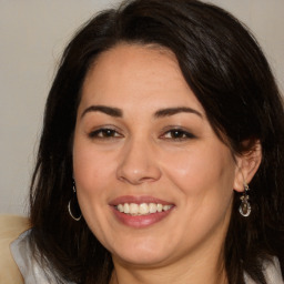 Joyful white adult female with long  brown hair and brown eyes