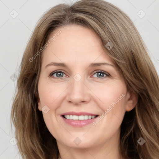 Joyful white adult female with long  brown hair and green eyes