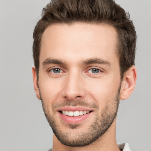 Joyful white young-adult male with short  brown hair and brown eyes