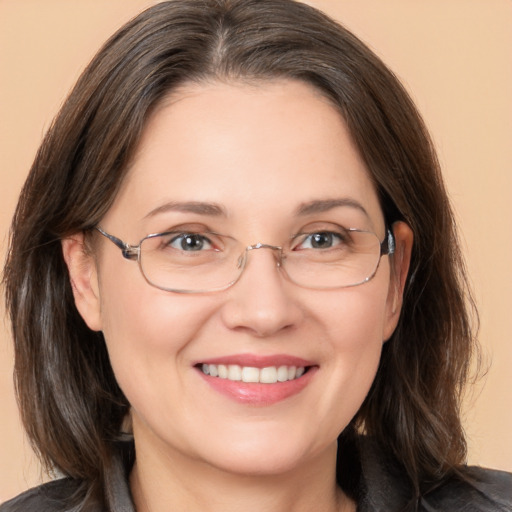 Joyful white adult female with medium  brown hair and brown eyes