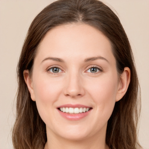 Joyful white young-adult female with long  brown hair and grey eyes