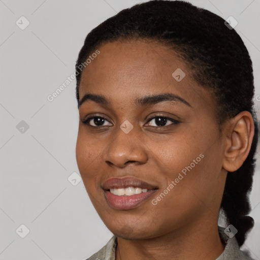 Joyful black young-adult female with short  black hair and brown eyes