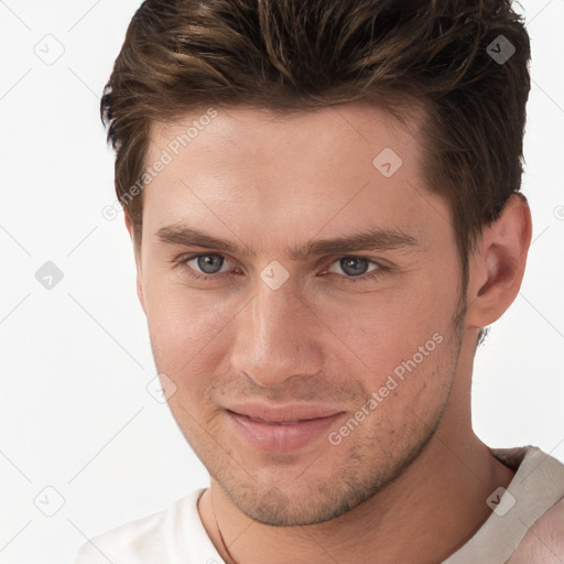 Joyful white young-adult male with short  brown hair and grey eyes