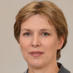 Joyful white adult female with medium  brown hair and grey eyes