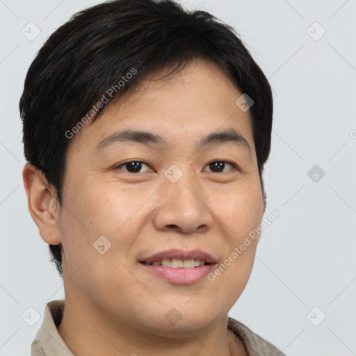 Joyful asian young-adult male with short  brown hair and brown eyes