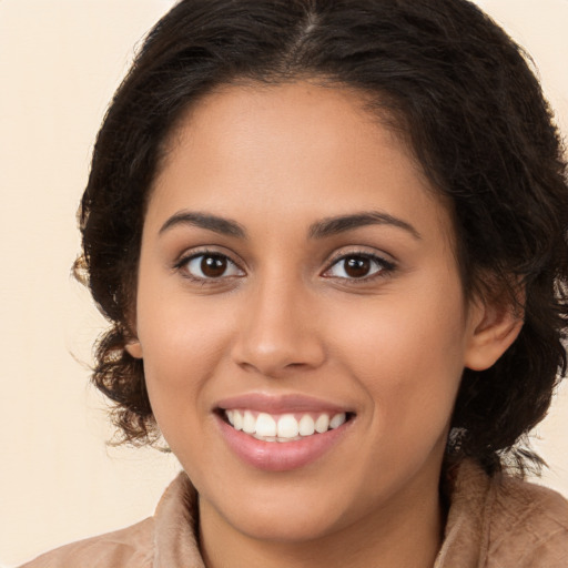 Joyful white young-adult female with long  brown hair and brown eyes