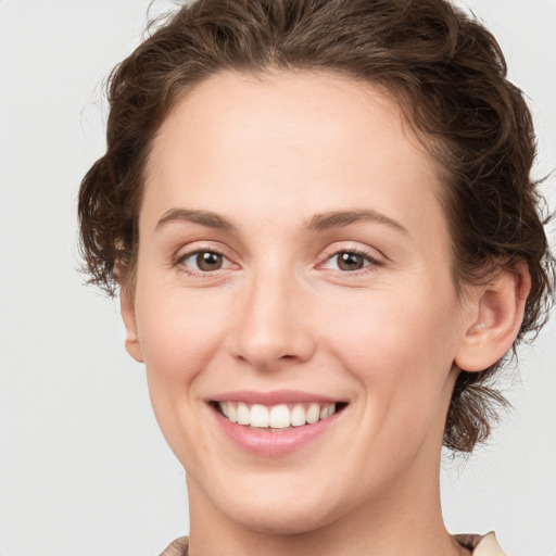 Joyful white young-adult female with medium  brown hair and green eyes