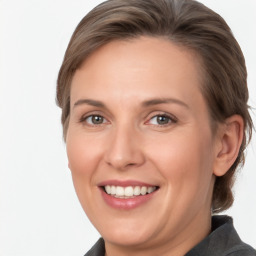 Joyful white adult female with medium  brown hair and grey eyes