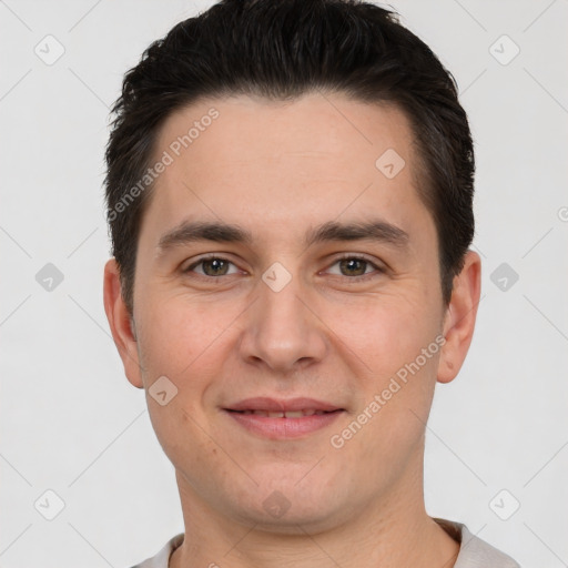 Joyful white young-adult male with short  brown hair and brown eyes