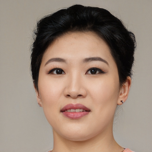 Joyful asian young-adult female with medium  black hair and brown eyes