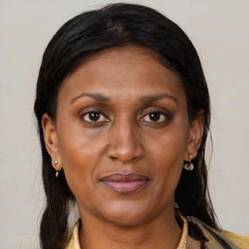 Joyful black adult female with medium  brown hair and brown eyes