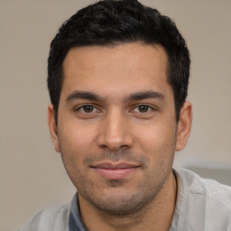 Joyful white young-adult male with short  black hair and brown eyes