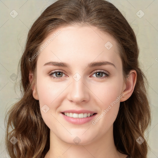 Joyful white young-adult female with long  brown hair and green eyes