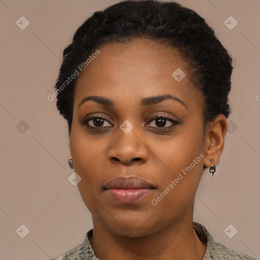 Joyful black young-adult female with short  black hair and brown eyes